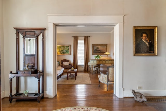 interior space with crown molding, baseboards, and hardwood / wood-style flooring