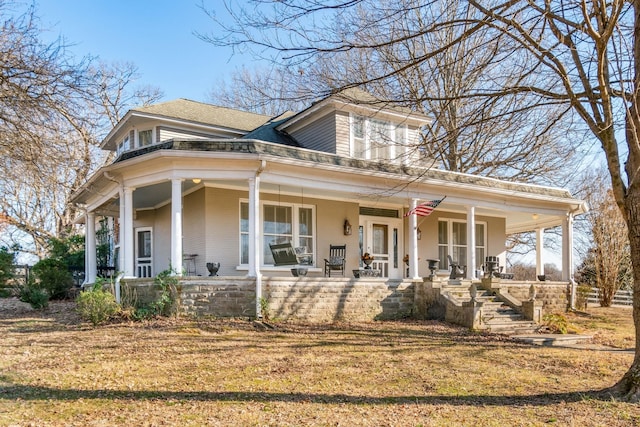 view of front of home with covered porch and brick siding