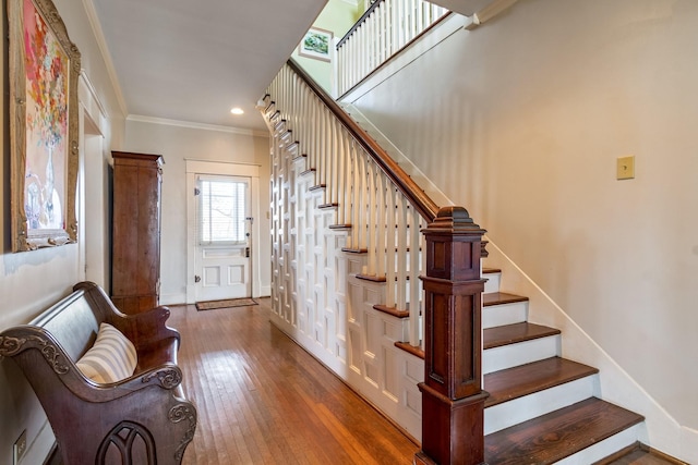stairs with crown molding, recessed lighting, baseboards, and hardwood / wood-style floors
