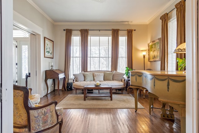 sitting room with ornamental molding and hardwood / wood-style floors