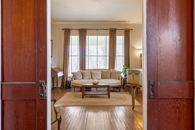 living room with ornamental molding and wood-type flooring