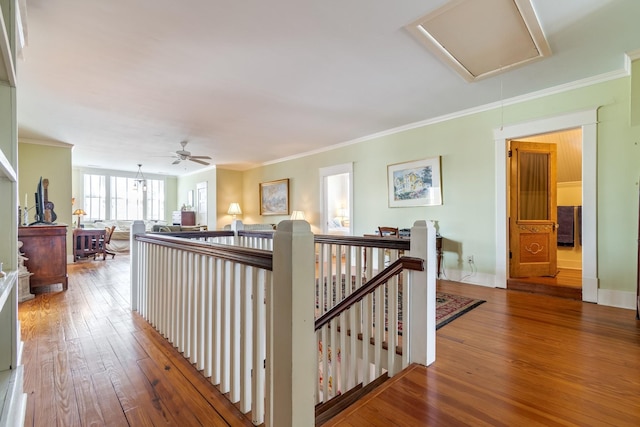 corridor featuring crown molding, attic access, an upstairs landing, and hardwood / wood-style flooring