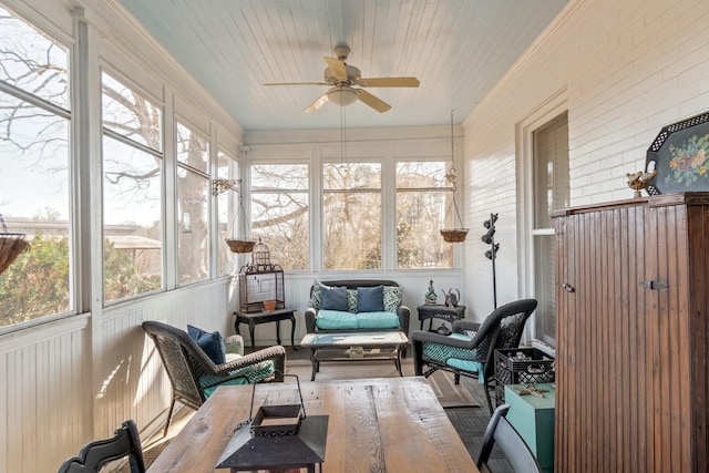 sunroom featuring an outdoor living space, a ceiling fan, and a wealth of natural light