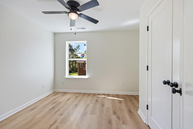 unfurnished room with baseboards, ceiling fan, and light wood-type flooring