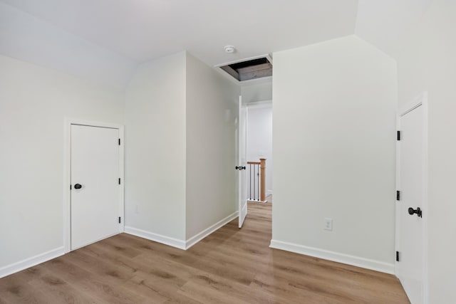 interior space featuring baseboards and light wood-style floors