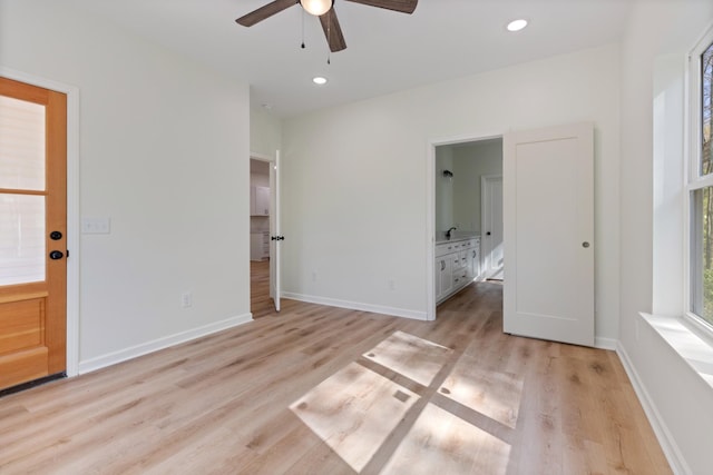unfurnished bedroom featuring ceiling fan, light wood finished floors, ensuite bath, recessed lighting, and baseboards