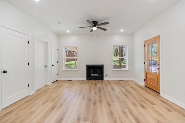 unfurnished living room with recessed lighting, ceiling fan, light wood-style flooring, and a fireplace