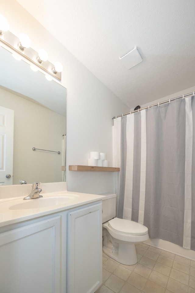 bathroom with toilet, curtained shower, and vanity