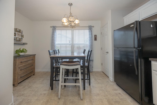 dining area featuring baseboards and an inviting chandelier