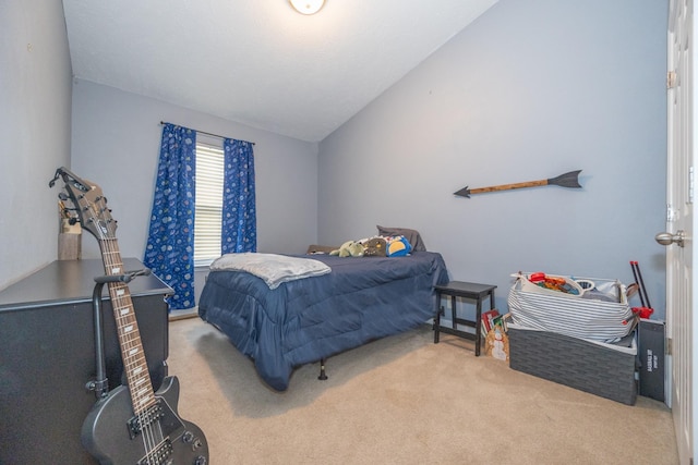 carpeted bedroom with lofted ceiling