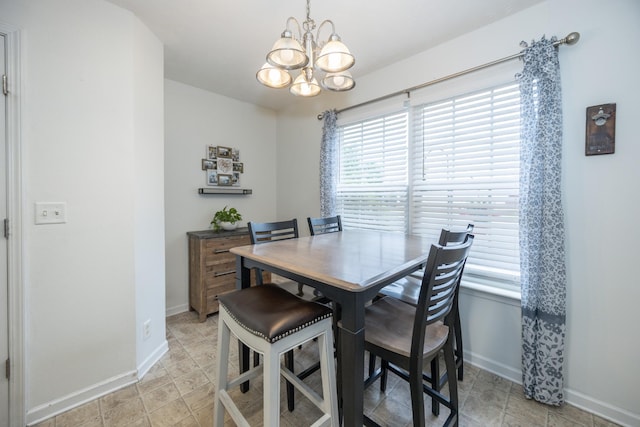 dining room featuring baseboards, a chandelier, and a wealth of natural light