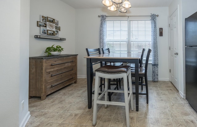 dining room with baseboards and an inviting chandelier