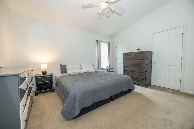 bedroom with light colored carpet, ceiling fan, and vaulted ceiling