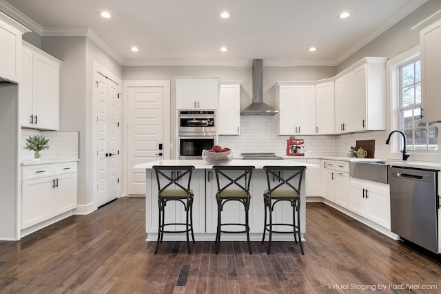 2509B Scovel St, Nashville, TN 37208 - kitchen with light countertops, wall chimney exhaust hood, appliances with stainless steel finishes, and dark wood finished floors