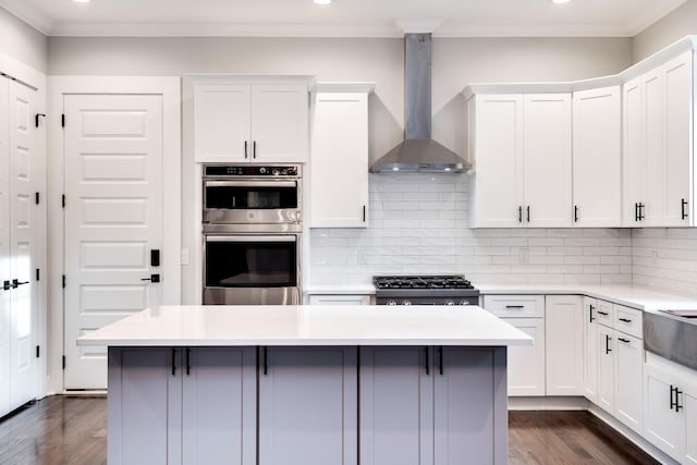 2509B Scovel St, Nashville, TN 37208 - kitchen with wall chimney range hood, recessed lighting, dark wood-type flooring, tasteful backsplash, and stainless steel appliances