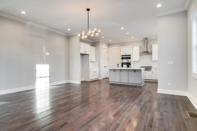 2509B Scovel St, Nashville, TN 37208 - kitchen featuring visible vents, wall chimney exhaust hood, white cabinets, dark wood finished floors, and stainless steel appliances