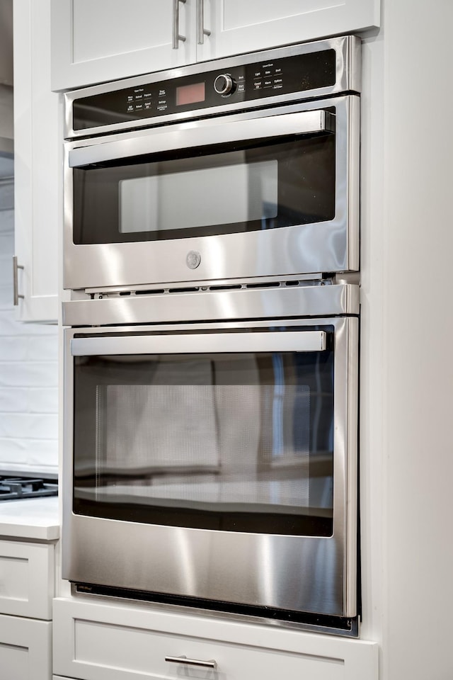 2509A Scovel St, Nashville, TN 37208 - details with stainless steel double oven, white cabinetry, and cooktop
