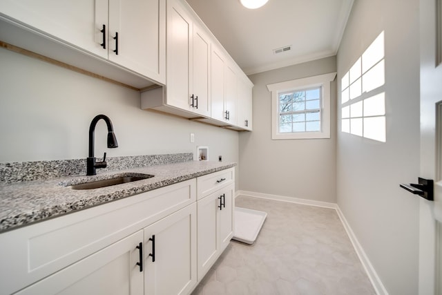 2509A Scovel St, Nashville, TN 37208 - laundry room with visible vents, crown molding, cabinet space, a sink, and hookup for a washing machine