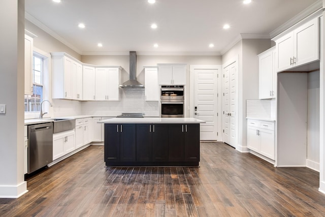 2509A Scovel St, Nashville, TN 37208 - kitchen featuring appliances with stainless steel finishes, light countertops, wall chimney exhaust hood, white cabinetry, and decorative backsplash