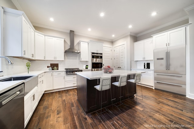2509A Scovel St, Nashville, TN 37208 - kitchen with a kitchen bar, appliances with stainless steel finishes, a sink, light countertops, and wall chimney exhaust hood