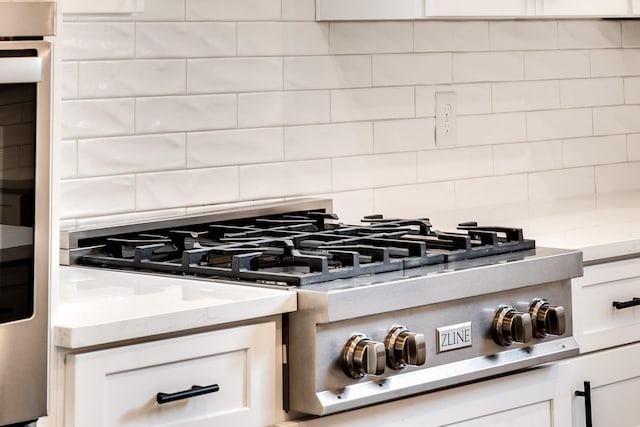 2509A Scovel St, Nashville, TN 37208 - room details featuring stainless steel gas cooktop, backsplash, and white cabinetry