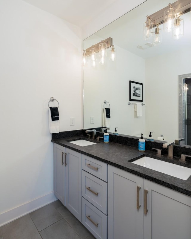 bathroom featuring double vanity, a sink, and tile patterned floors