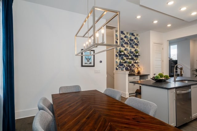 dining area featuring dark wood finished floors, baseboards, an inviting chandelier, and recessed lighting
