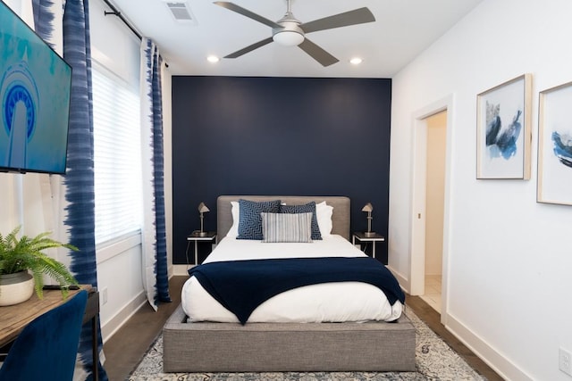 bedroom with a ceiling fan, visible vents, wood finished floors, baseboards, and recessed lighting