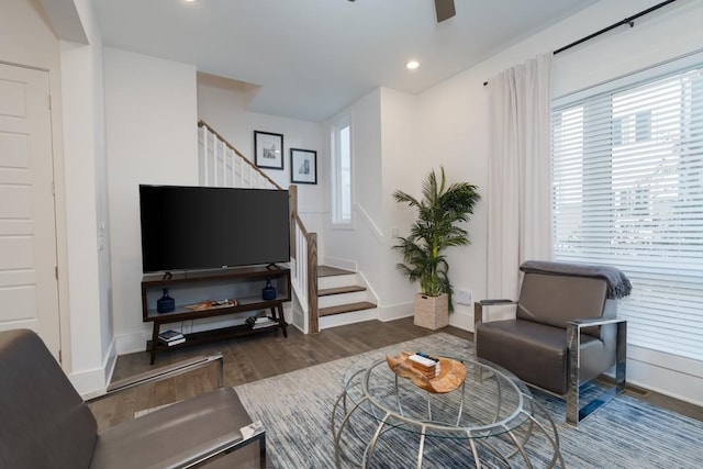 living area featuring stairs, wood finished floors, baseboards, ceiling fan, and recessed lighting
