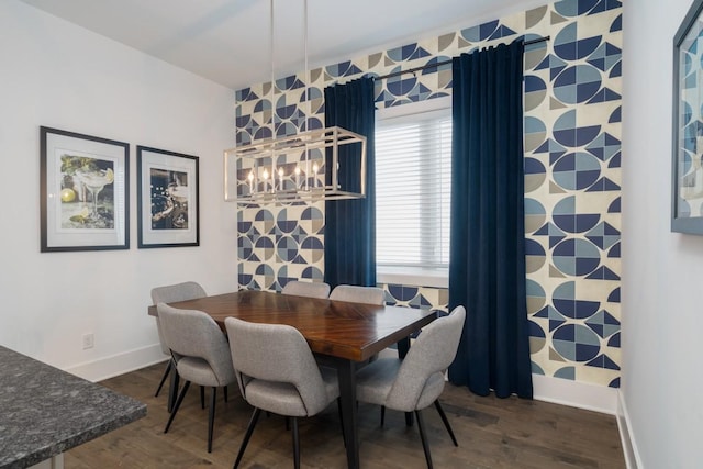 dining room featuring baseboards, dark wood-style flooring, an inviting chandelier, and wallpapered walls