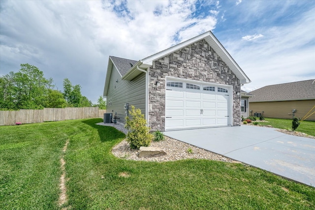 view of home's exterior with concrete driveway, an attached garage, fence, and stone siding