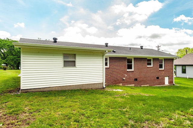 154 Church Ave, Watertown, TN 37184 - back of property with a shingled roof, brick siding, and a lawn