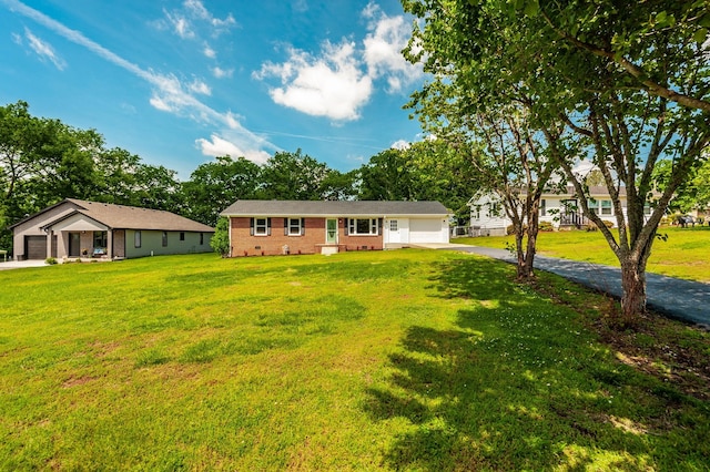 154 Church Ave, Watertown, TN 37184 - ranch-style house with a front lawn, brick siding, driveway, and a garage