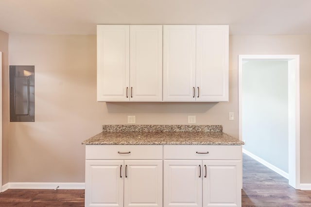 154 Church Ave, Watertown, TN 37184 - kitchen featuring electric panel, dark wood finished floors, light stone counters, and baseboards