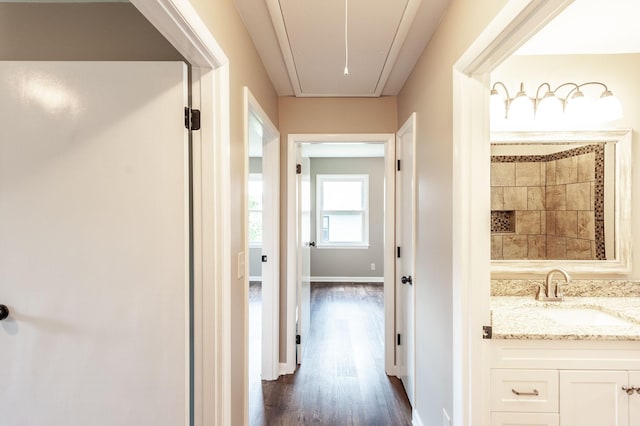 154 Church Ave, Watertown, TN 37184 - hallway featuring baseboards, dark wood-style flooring, attic access, and a sink