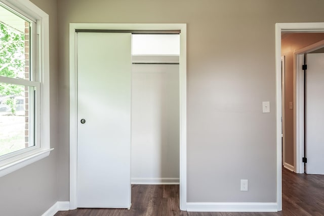 154 Church Ave, Watertown, TN 37184 - unfurnished bedroom featuring multiple windows, a closet, and dark wood-style flooring