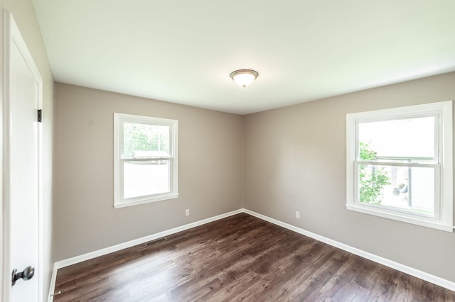 154 Church Ave, Watertown, TN 37184 - empty room featuring baseboards, visible vents, and dark wood-type flooring