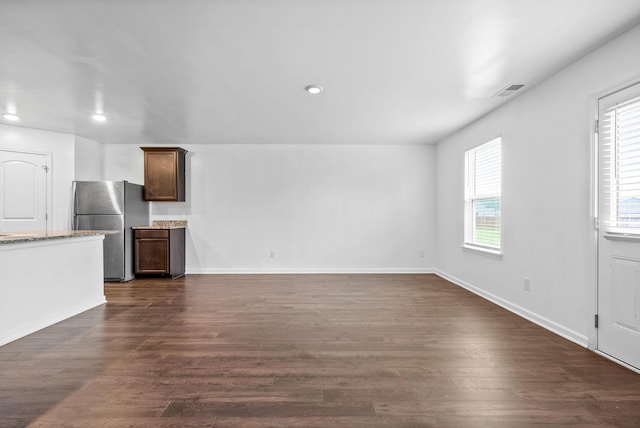 unfurnished living room featuring recessed lighting, dark wood-style flooring, and baseboards