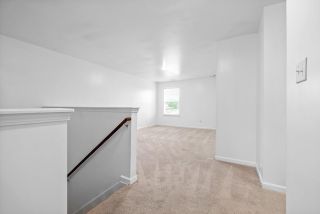 below grade area featuring carpet floors and baseboards