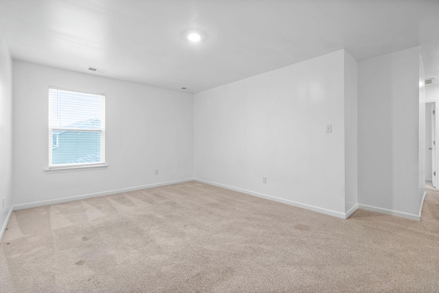 empty room with carpet and baseboards