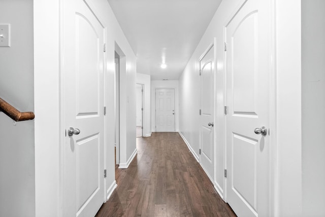 hall featuring dark wood finished floors and baseboards