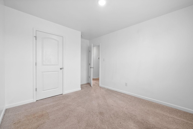 unfurnished bedroom with carpet and baseboards