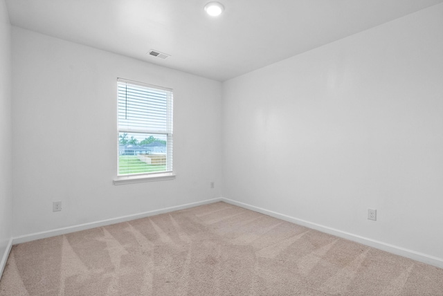 unfurnished room with baseboards and carpet flooring
