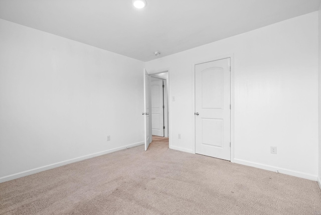 unfurnished bedroom with light carpet, baseboards, and recessed lighting
