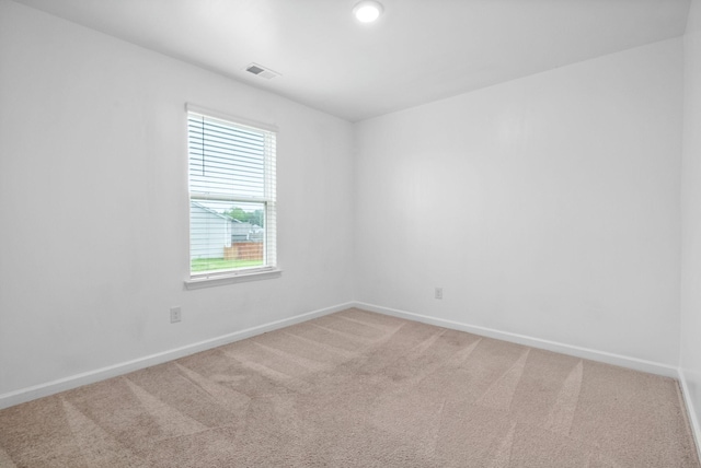 empty room with baseboards and light carpet