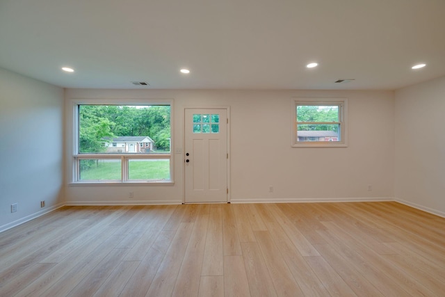 interior space with baseboards, visible vents, and light wood-style flooring
