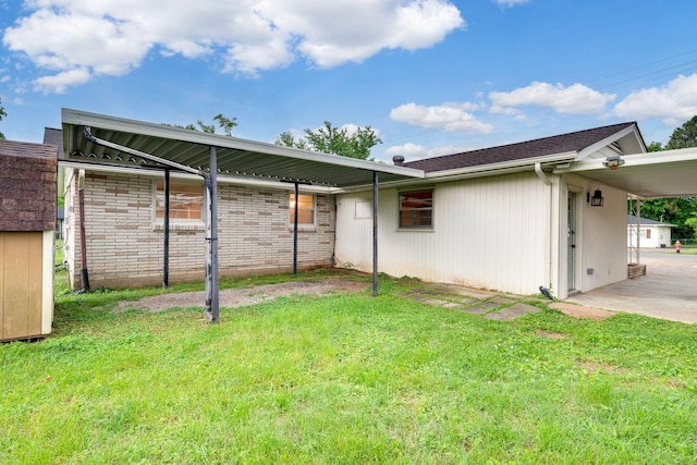 back of property with a lawn