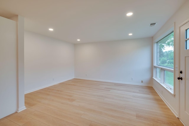 spare room with visible vents, recessed lighting, light wood finished floors, and a healthy amount of sunlight
