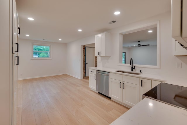 kitchen with white cabinets, a sink, light wood-style floors, dishwasher, and visible vents