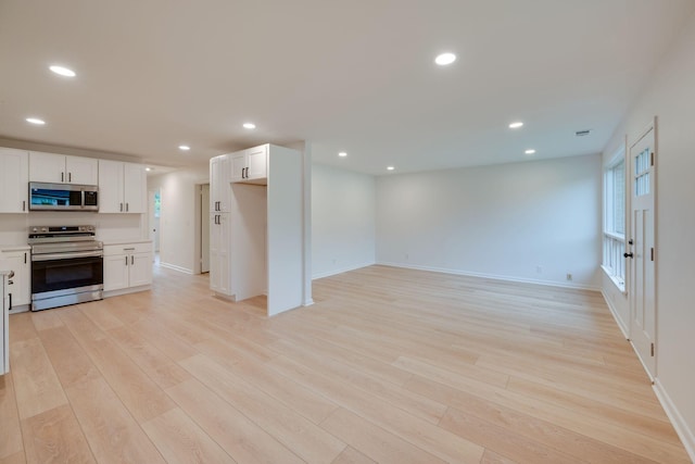 kitchen featuring recessed lighting, light wood-style flooring, white cabinetry, and stainless steel appliances